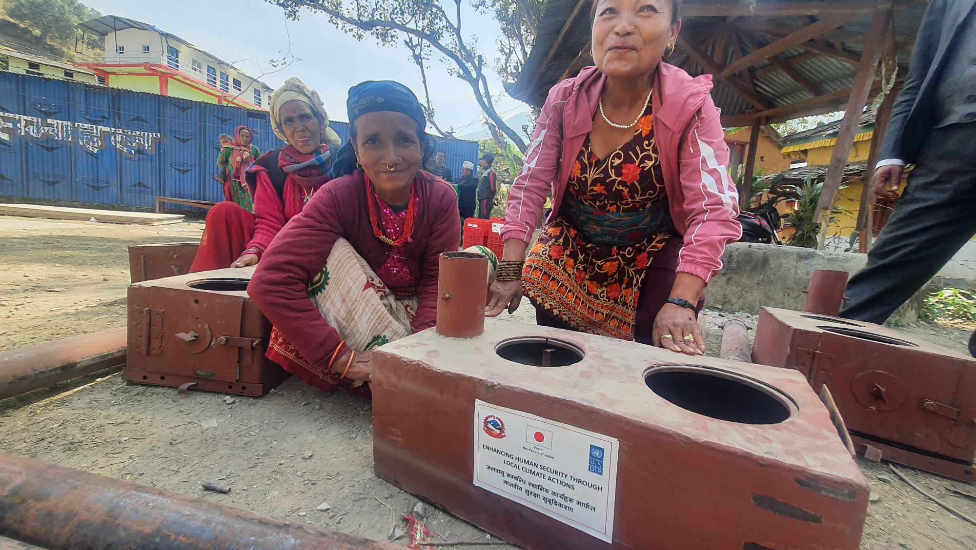 2 ladies posing in front of their new stoves